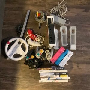 Nintendo wii with controllers, controller covers, games